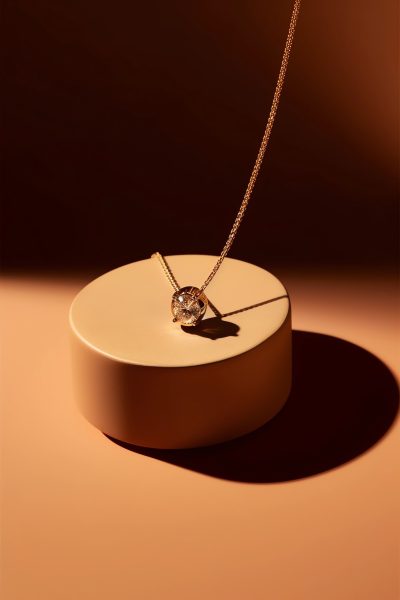 a piece of fine jewelry, golden hour, professional photography, minimal background