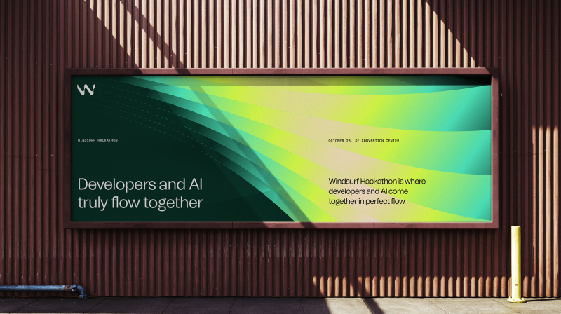 Large billboard on a building wall promoting the Windsurf Hackathon, with vibrant green and yellow wave graphics. Text reads: “Developers and AI truly flow together” and includes date and location details.